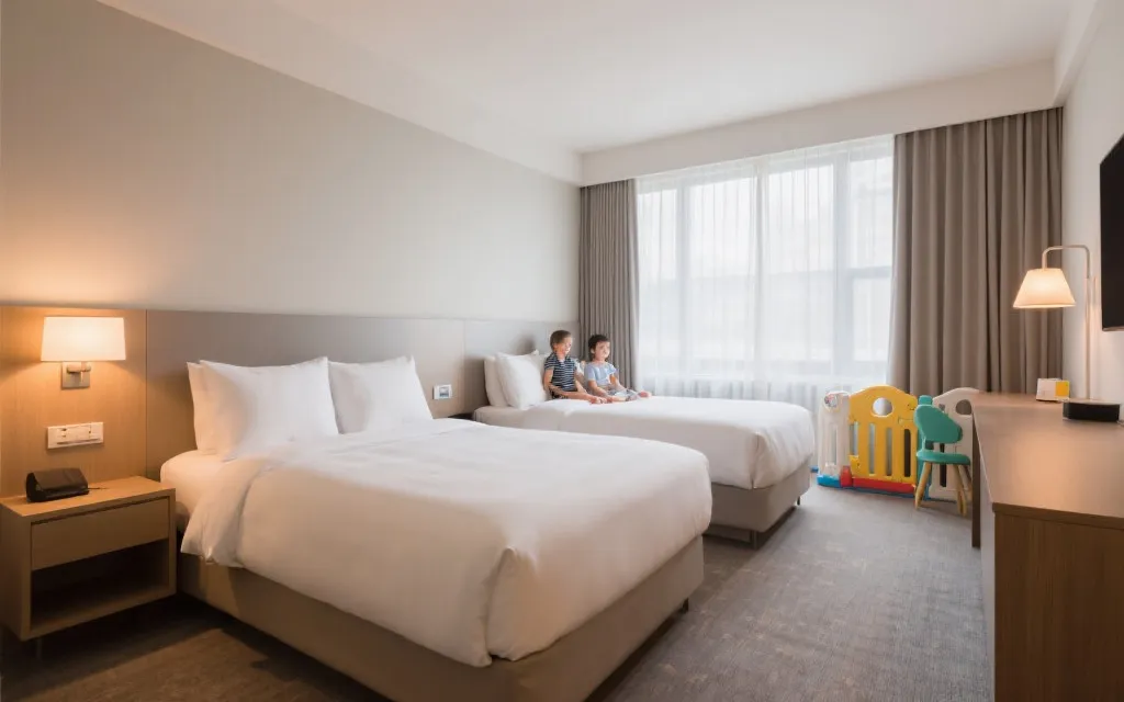 安静的家庭酒店房间内景，床铺整洁，柔和灯光，儿童用品收纳